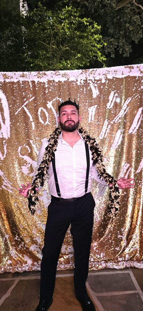 Top Shelf night: guest in a crown and feather garland at the gold sequin backdrop
